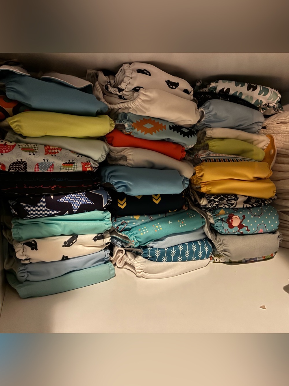 36- Stacked Cloth Diapers in Aqua, Yellow, Blue, Green and Red Accents